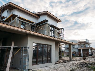 close-up shot of contemporary building construction with scaffolding under cloudy sky