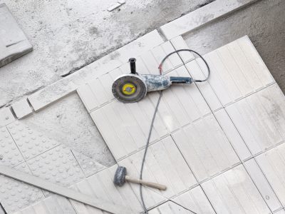 Construction tools on sidewalk under repair. Construction background