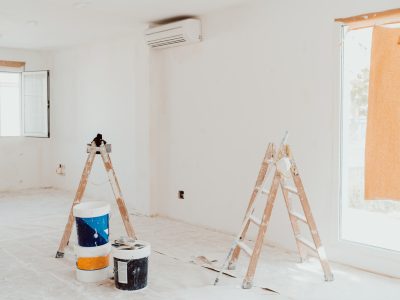 ladders and pots on white room at construction site. Painting walls. Home improvement, renovation